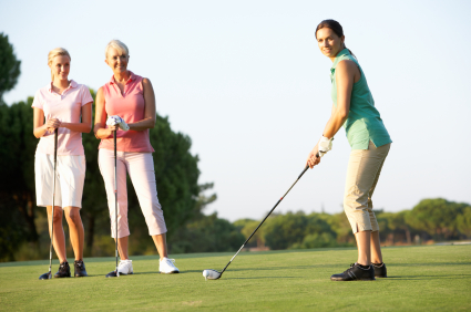 Group Of Female Golfers Teeing Off On Golf Course